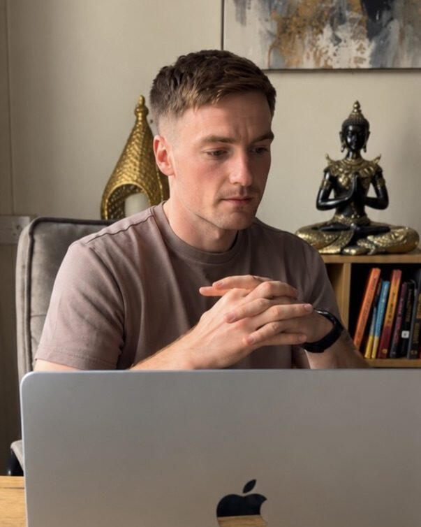 Aaron Bergin seated at a laptop.